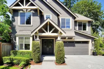 This view showcases the elegance and charm of the home, featuring grand double entry doors that create a welcoming and sophisticated entrance.  The spacious 3-car garage (one tandem) and ample parking in front and to the side ensure that you will have no trouble accommodating multiple vehicles or providing extra space for guests