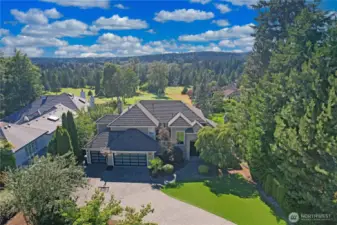 This lovely home sits above the course on the 9th T - safe from stay golf balls