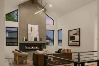 This great room impresses with 17-ft ceilings, a sleek 62” Napoleon Vector fireplace, a fir-wrapped glulam beam, and built-in surround-sound speakers