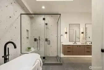 Luxurious primary suite with tall ceilings, a custom walk-in closet, in-suite washer/dryer space, and a 5-piece spa bath with heated floors.