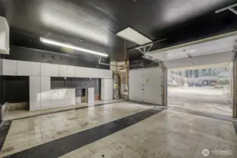 This property features an oversized, two-car garage that boasts high ceilings, providing exceptional space for vehicles and storage. In addition to the garage, there is extra attic storage, along with built-in cabinets, perfect for organizing and storing items or setting up a dedicated space for hobbies.