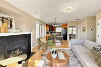 Spacious living area with fireplace and open flow to kitchen