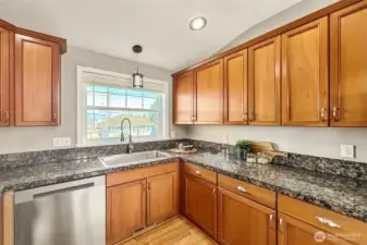 Bright kitchen with granite counters and ample cabinetry