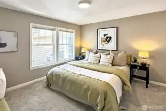 Spacious primary bedroom with natural light