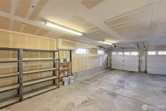 Large garage with built-in shelving and storage space