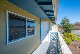 Primary Bedroom window faces the Balcony and the doorway back into the Living area.
