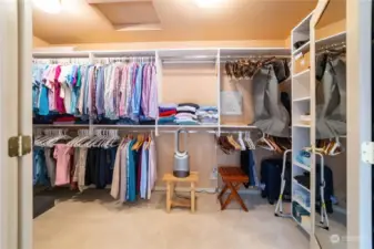 The custom organized expansive walk-in closet, accessed by two doors.