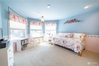 One of the bedrooms, nicely sized, carpeted, and with custom paint and wallpaper.