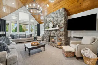 Vaulted living room with river rock gas fireplace