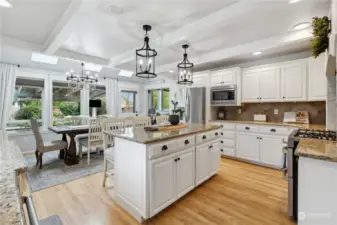 Chef's kitchen with solid wood cabinets, stainless appliances and lots of counter space.