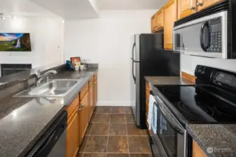 This classy kitchen features and black and stainless color scheme.