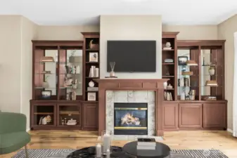 Living room focal point with gas fireplace and mantle. Custom built in's