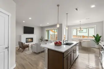 Virtually staged living, kitchen and dining.