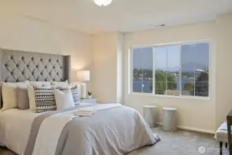 The primary suite with views of the lake form large picture window