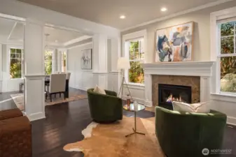 The formal living room with gas fireplace, hardwood floors & layers of millwork.