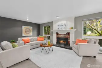 A gorgeous mantle and fireplace surround and hearth frames the gas fireplace highlighting the expansive living room. Designer top-down, bottom-up shades cover huge picture windows.