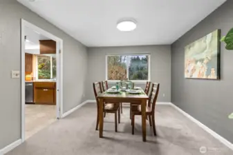 View the private back yard from the dinning area and watch the seasons change.  Plush carpet and handsome white trim and millwork highlight this lovely, timeless home.