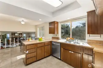 Recessed lighting, updated counter tops and practical, easy care laminate flooring make clean up a breeze.  Watch the backyard fun from the kitchen window, or enjoy a serene back yard with private view.