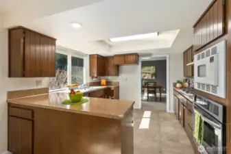 Looking back from the kitchen eating space, shows the refrigerator space ready for your own appliance.