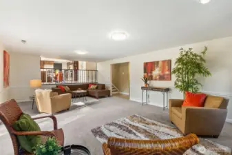 Another view of one end of the family room shows the visual connection and stairs that lead up to the main living space.  Great birds eye view from the kitchen of family room activity.