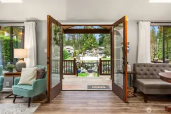 Let the outside in, large wood french doors open to cedar deck and lake access