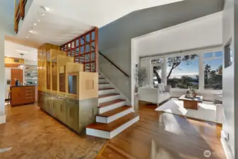 Inside the entryway, stair step maple cabinets are just the first piece of interesting architecture