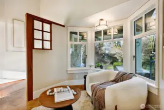 A cozy reading nook looks out to the front garden