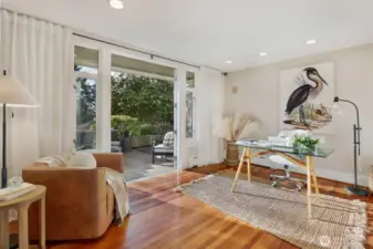 Behind the living room sits a large office or media room with french doors to the western facing patio