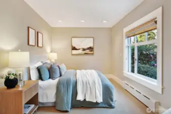 Main floor bedroom tucked on the east side looking over the beautiful front yard and garden space