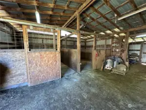 Inside the barn, this photo shows some of the stalls located on the right side.