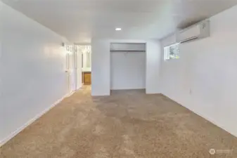 Primary Bedroom is large with windows for ambient light.