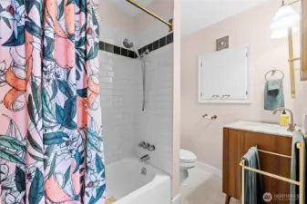 Subway tiled tub/shower, updated vanity and built in storage