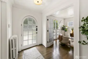 Arched primary door and windows ground the home in classically charming detail. Thick moulding and woodwork is gorgeous.