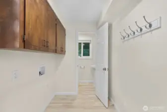 Laundry room with powder room in back of photo.