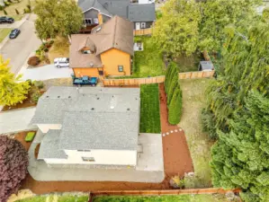 Mature landscaping and fresh sod are ready for pets and outdoor activities.