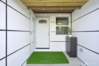 Inviting front entry with fresh siding.