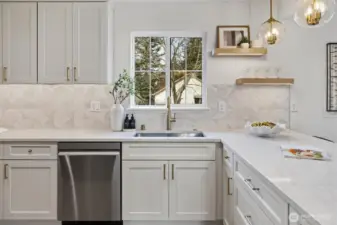 A beloved window above the sink overlooking the yard and a five function kitchen faucet persuading you to wash those dishes