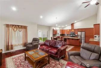 The living room flows seamlessly into the dining and kitchen areas.