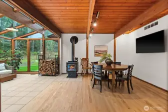 The ultimate Sunday morning spot. This eating area balances high-end design with the timeless, sensory comfort of a traditional wood fireplace while highlighting this kitchen's open concept living.