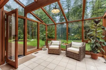 The ultimate expression of indoor-outdoor living. The transition from the timber-lined sunroom to the expansive deck creates a seamless entertaining flow.