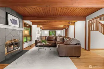 The heart of the home. This expansive living area offers the perfect balance of grand architectural volume and the cozy, intimate warmth of a flickering hearth.