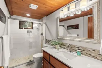 Bright, clean, and inviting. This shared bathroom maintains the home's airy feel, offering a spa-like retreat for guests and family alike.