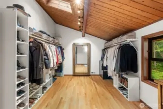 Find comfort in knowing your organizational clothing needs are et in this expansive walk-in primary closet.