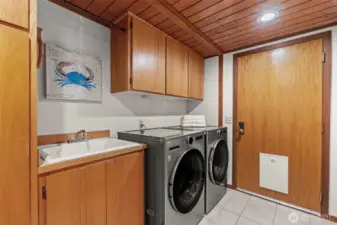 The ultimate 'mudroom' transition. The integrated doggy door provides effortless freedom for four-legged residential members while keeping the main living areas pristine.