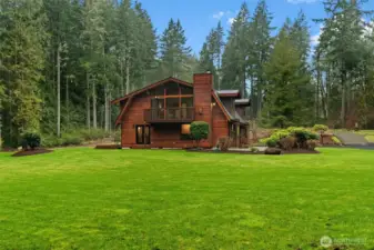 Expansive and pristine. This gorgeous backyard setting is a perfect backdrop to this stunning cedar home.