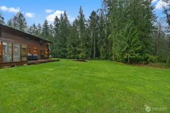 Enjoy backyard access through the sunroom or dining room, bordered with beautiful evergreens for a tree-lined, private property.