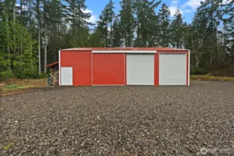 Enjoy this convenient outbuilding located on the backside of the property, with capable storage accommodating up to 6 cars or 2 oversized vehicles.