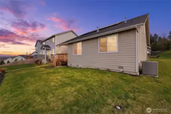 The southwest corner of the home shows the heat pump tucked around the corner.