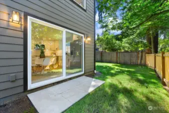 Backyard patio with large sliding door for indoor/outdoor living.