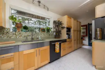 Gorgeous green stone countertops really make this a special space.